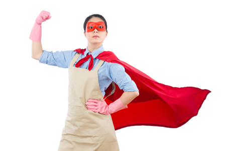 confidence superhero house cleaner showing her powerful muscle arm with wearing red cloak and goggles. isolated on white background. housework and household concept.の写真素材