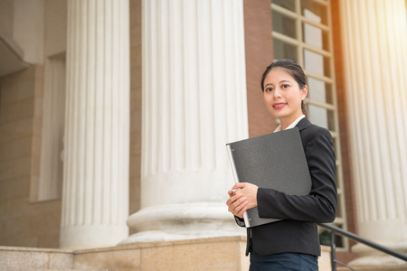 smile beautiful legal adviser manager standing in court prepare law data file document provided to defendant or plaintiff professional legal provisions.の写真素材
