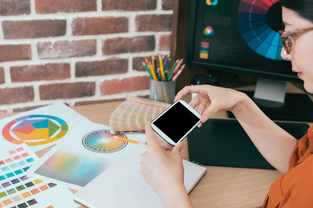 closeup of beauty sweet woman using mobile smartphone taking photo about design case when she finished new creation work.の写真素材