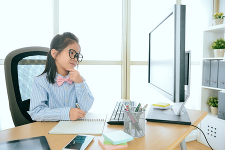 beauty smiling business girl writing record on book and looking at working computer thinking company...