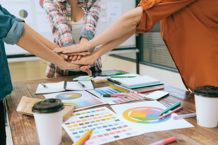 business designer team hands together hoping new season design case successful when they meeting together on conference desk.の写真素材