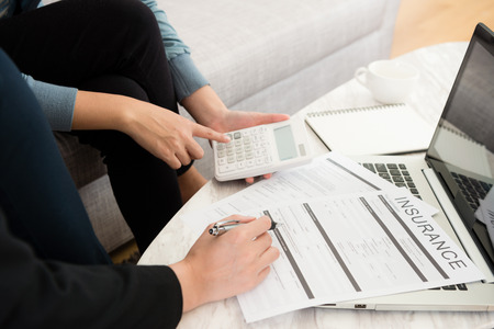 closeup of businesswoman with customer discussing invest plan and using calculator tool counting suitable price.の写真素材