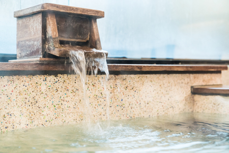 hot spring water come out from bathtub and fill in to the bath.