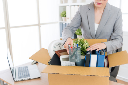 elegant attractive business woman packing personal company belongings when she deciding resignation and changing work in future.の写真素材
