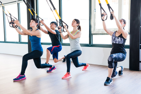 total body resistance exercise trainer training together squat and pull up for whole body muscle workout.の写真素材