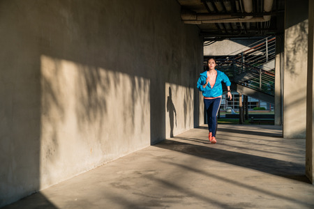 Active healthy lifestyle girl doing exercise workout outdoor. Motivation for weight loss, urban life. Fitness sport and healthy lifestyle concept.の写真素材