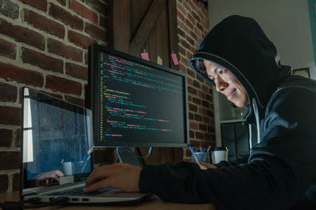 man using electronic devices to blackmail people and getting illigal money for makiing a living.の写真素材