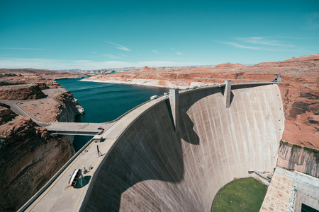 View down dam lake powell on sunny blue sky in summer. clean river water surrounding by desert in usa. beautiful nature wild in america.の写真素材
