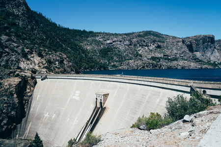 O'Shaughnessy Dam at Hetch Hetchy Reservoir in Yosemite National Park with blue sky. The source of water for San Francisco CA USA. beautiful wild nature lake on sunny day in summer.の写真素材