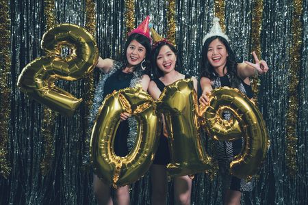 Young Asian Ladies Showing Victory Finger Sign Face Camera Smiling Group Of Charming Women Carrying Colored 19 Number Gold Balloon Countdown New Year Eve At Nightclub Cheerfully Night Lifestyle Royalty Free Images Photos