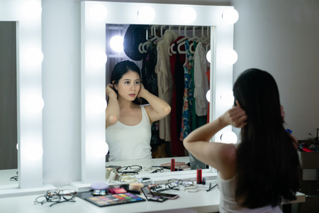 pretty young sensual japanese model woman with beautiful makeup and elegant hairstyle looking at her...