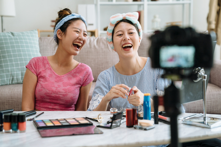 young friends in headbands introduce new seasonal summer cosmetic.の写真素材