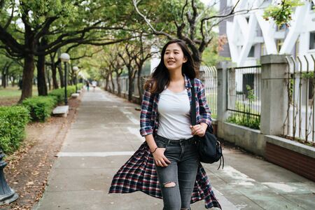 asian young woman tourists walking on pathway in park in Barcelona Spain.