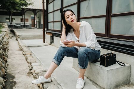 tourist Asian chinese girl using mobile phone enjoying summer travel holidays. young woman visiting...