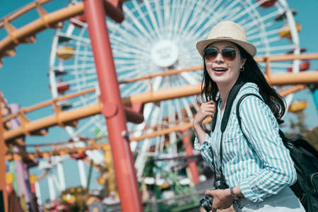 Happy asian chinese young girl backpacker having fun on spring break holiday. Cheerful woman on...
