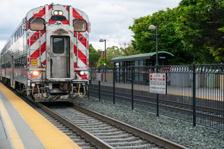 California, USA - May 16, 2018: diesel locomotive of CalTrain approaching platform at the station on a cloudy day. commuter rail line serving in San Franciscoのeditorial素材