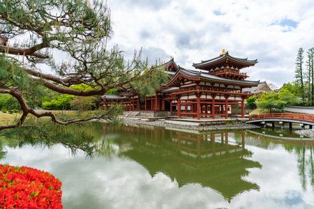 Kyoto, Japan - April 18, 2018: world cultural heritage site phoenix hall and its water reflection on aji-ike pond at Byodoin Temple in uji during spring seasonのeditorial素材