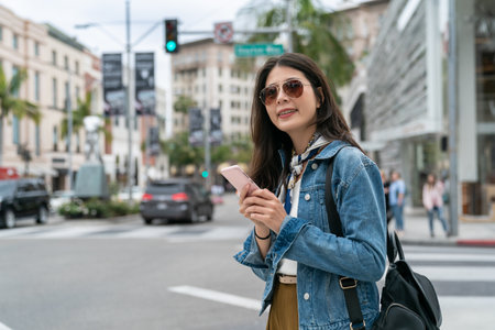 beautiful girl using smartphone to search the location of her favorite Jewelry shopの写真素材