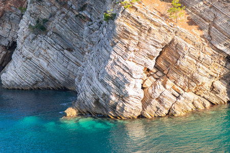 Turquoise sea framed by a rocky shore, bright sunny day. The concept of rest, travel.の写真素材