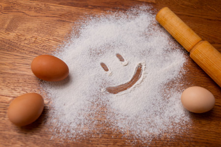 Organic homemade eggs in a bowl with kefir or milk. Cooking. Whisk in female handsの写真素材