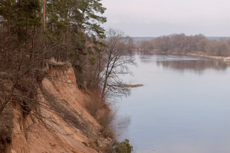 Early spring, river cliff, brown tones, river overflowの写真素材