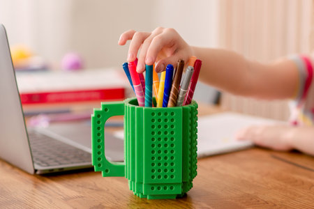 A schoolgirl studies at home. Distance learning at home.の写真素材