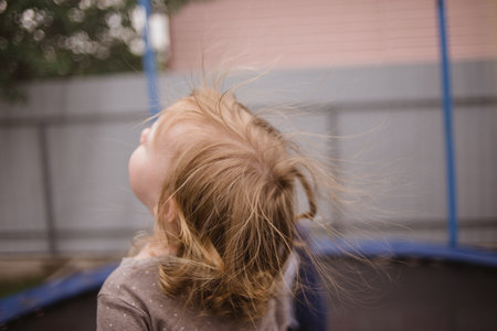 cheerful beautiful child jumping on a trampoline