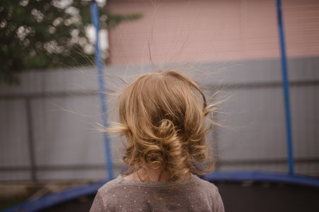 cheerful beautiful child jumping on a trampolineの写真素材