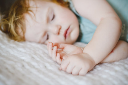 little baby sleeping. Close-up of the babys face and handsの写真素材