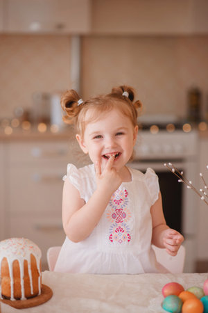 happy cute girl is preparing for easter. smiling girl paints eggs