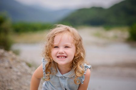 A beautiful child near the highlands. Girl with a smile.の写真素材