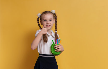 Cute funny schoolgirl getting ready to go back to schoolの写真素材