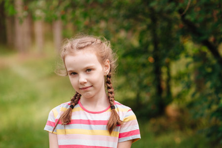 Portrait of a smiling girl against a green backgroundの写真素材