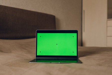 The laptop is on the bed. Green screen laptopの写真素材