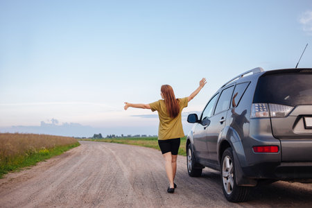 The girl travels by car, rests and enjoys natureの写真素材
