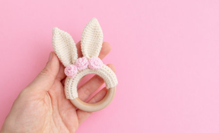Childrens eco-toys. Wooden teething teether with knitted toy