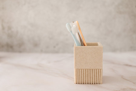 A close-up of four toothbrushes in a cup. High quality photoの写真素材