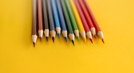 Lots of colored pencils on the yellow background of the desk. Back to school. Children's Creativity and Education. High quality photoの写真素材