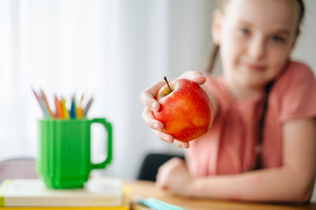girl holding an apple, back to school