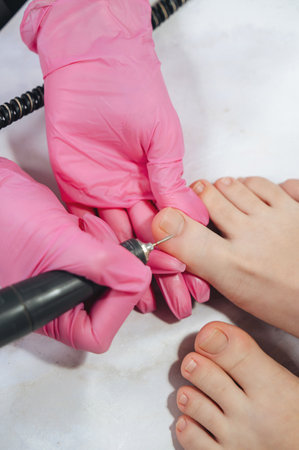 A close-up of women's feet with a natural pedicure, without gel polish, highlighting soft, well-groomed skin and minimalist beauty careの写真素材