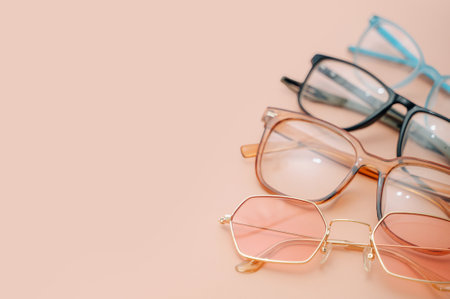 Eyeglasses for nearsightedness or farsightedness placed on a peach backgroundの写真素材