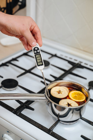 Fragrant mulled wine with spices and fruits in saucepan.