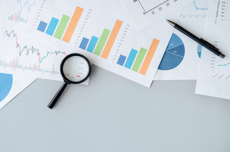 Magnifying glass on table for financial analytics research.