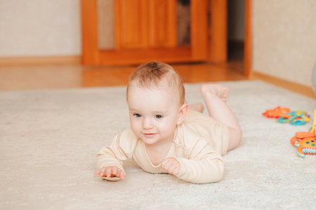 Happy baby learning to crawl.の写真素材