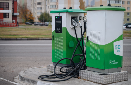 Electric car charger station in city, sustainable transport concept.の写真素材