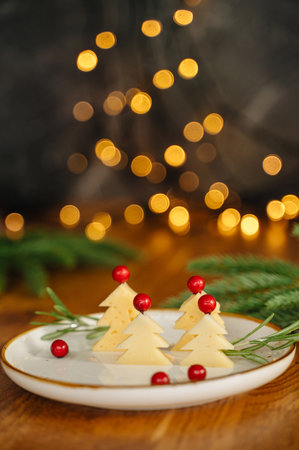 Christmas snack in the form of trees. Delicious cheese with christmas background. High quality photoの写真素材