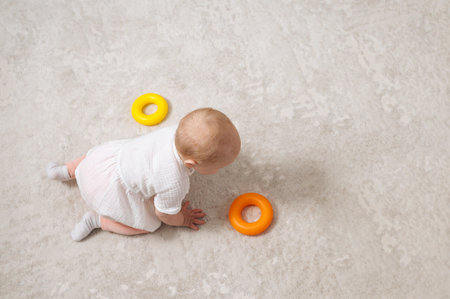 healthy curious child plays with colorful toy. High quality photoの写真素材