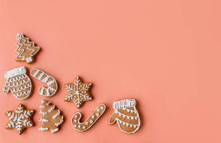 Different gingerbread cookies on peach background, flat lay. High quality photoの写真素材