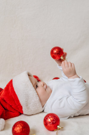Cute little girl holding Christmas baubles, festive holiday portrait.の写真素材