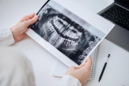 Panoramic image of a child jaw in the hands of a dentist for pediatric dental consultation.